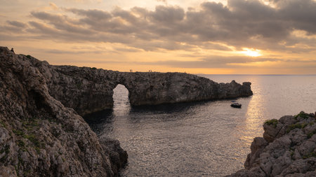 Pont d'en Gil, on the island of Menorca. Iconic arch in the sea, seen from the top of a cliff, popular for admiring the sunset and taking nature photos. Balearic islands tourismの写真素材