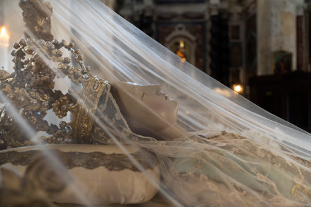 Cagliari, Italy - August 22, 2023: Close up of Sculpture of the Dormition of the Virgin, a sleeping representation, awaiting the resurrection and ascension to heaven with a veil over her in the Cathedral of Cagliari, Sardiniaのeditorial素材