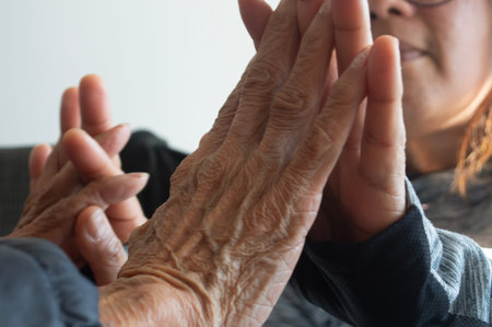 the hands of a lady and an old woman