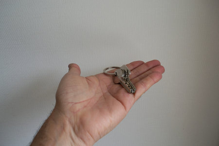 a man's hand holding some keys