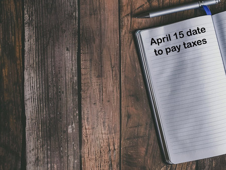 a notebook with the date of April 15, the date to pay taxesの写真素材