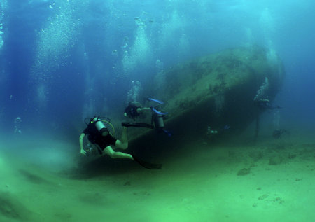 a diver exploring a sunken ship off the coast of Arubaの写真素材