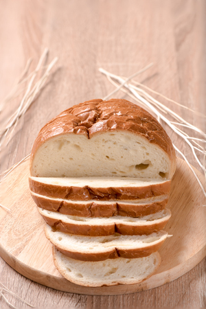 bread on chopping block in wood backgroundの写真素材
