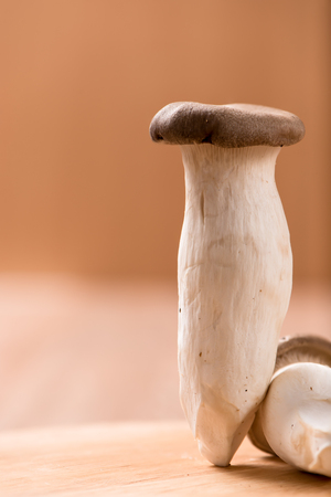 King oyster mushroom on chopping block ,wood tableの写真素材