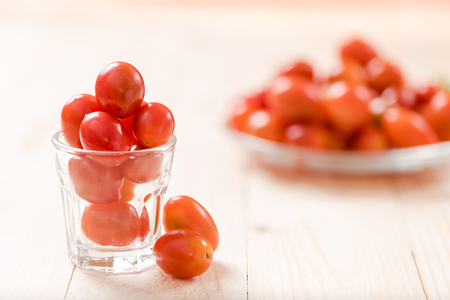 Cherry tomatoes on wooden backgroundの写真素材
