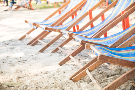 summer vacation, tourism, travel, holidays and people concept, folding chair on beach,blurred background on the beachの写真素材