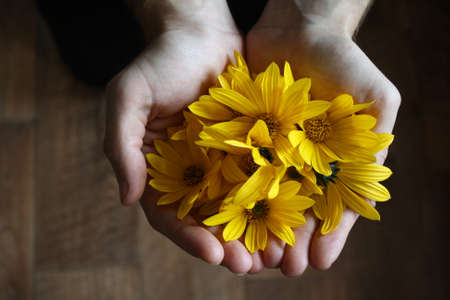 flowers in his handsの写真素材