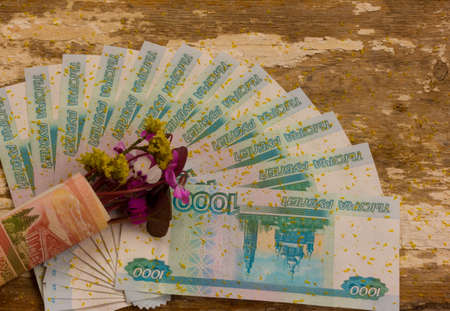bouquet of flowers wrapped in a dollar billの写真素材
