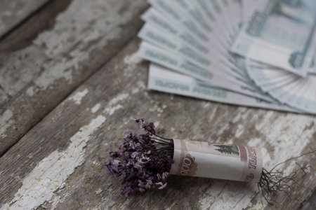 bouquet of flowers wrapped in a dollar billの写真素材