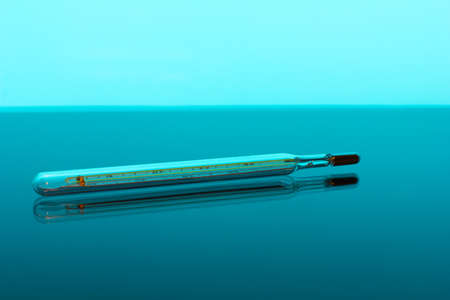 medical thermometer lying on the glass tableの写真素材