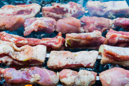 preparation of a shish kebab from pork meat on coalsの写真素材