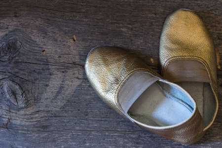 gilded gymnastic slippers from skin on a floorの写真素材