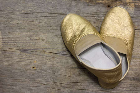 gilded gymnastic slippers from skin on a floorの写真素材