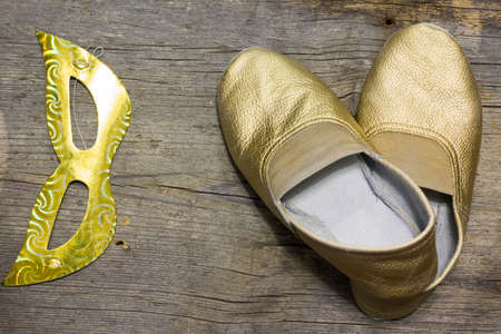 gilded gymnastic slippers from skin on a floorの写真素材