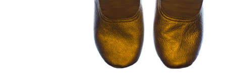 forward part of the sports slippers of golden color isolated on the whiteの写真素材
