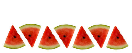 isolated on white background triangular slices of ripe watermelon laid out in a rowの写真素材