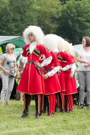 DAKHOVSKY, RUSSIA - JULY 25 2015: Boys Muslims in national Adyghe suits prepare for performance. The Festival "Lago-Naki: Kunatskaya" was held in the mountains of Adygea in Dakhovsky, Russia, July 25 2015のeditorial素材