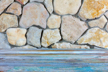 texture grunge wooden countertop near the wall built of stone limestoneの写真素材