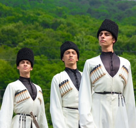 Adygea, RUSSIA - JULY 25 2015: Young guys in Adyghe national costumes dancing traditional dance at an ethnofestival in the Foothills of Caucasus in Adygeaのeditorial素材