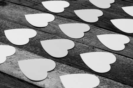stickers for messages in the shape of a heart laid out in rows diagonally. The concept of love, romance, Valentine's day. Copy space. Black and white photo. Selective focusの写真素材