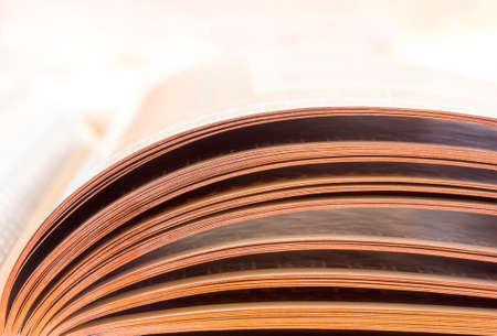 the leaves of an open book lit by daylight, close-upの写真素材