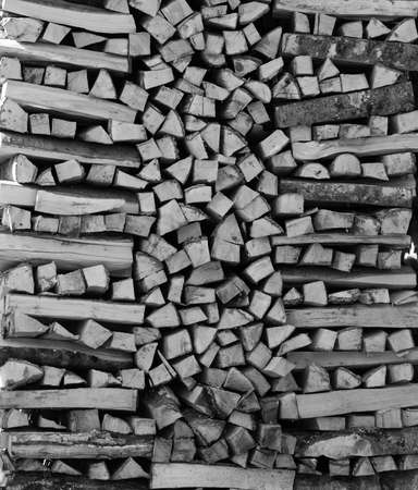 chopped firewood kiln and stacked in the woodpile. copy space. Free space for text. black and white photoの写真素材