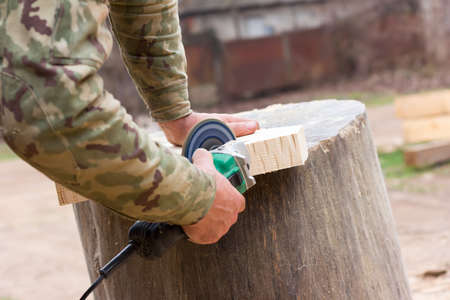 white guy handles grinder wooden detail. the concept of manual labor, freelance. selective focusの写真素材