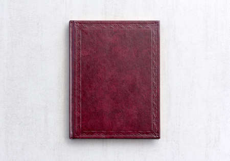 book dark purple color on gray background close-up, top viewの写真素材
