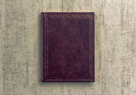 purple book on a grey grunge background, top view, retro toned imageの写真素材
