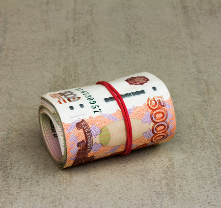 Roll Russian banknotes on a gray background closeup. Selective focusの写真素材
