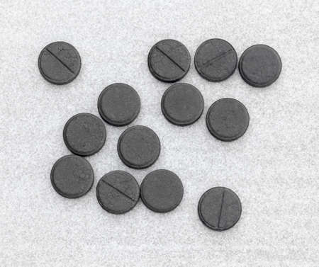 Activated Charcoal Tablets For Cleansing The Body On A Gray Background. Top View Closeupの写真素材