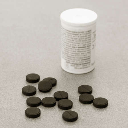 Activated Charcoal Tablets For Cleansing The Body On A Gray Background Closeup. Black And White Photoの写真素材
