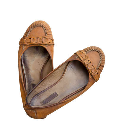 old pair of women's shoes made of genuine leather isolated on a white background, top view closeupの写真素材