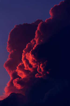 Abstract background, landscape with red clouds in the evening sky in the rays of the setting sunの写真素材