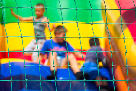 blurry abstract background, the boys play on the trampoline, can be used for illustration of articles about childrens entertainmentの写真素材