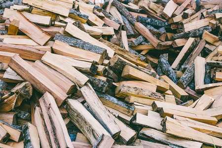a pile of chopped wood for the stove and fireplaceの写真素材