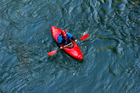 Adygea, Russia - October 10, 2017: sportsman kayaker comes down on a kayak along the mountain river Belaya in Adygea in the autumn time, the top viewのeditorial素材
