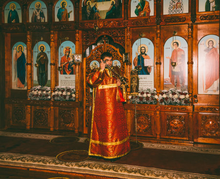 Adygea, Russia - November 8, 2017: a young deacon censes the censer before the altar at the divine Liturgy in the Orthodox Churchのeditorial素材