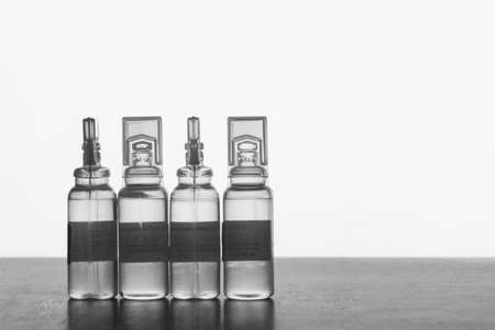 Plastic ampoules with solution for injections on a gray background with space for textの写真素材