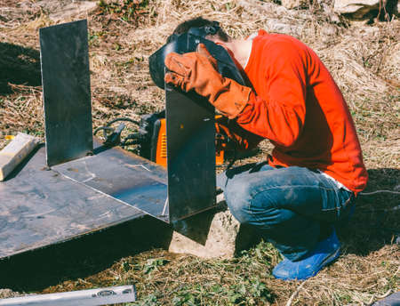 a welder puts the seam on the metal electro arc weldingの写真素材