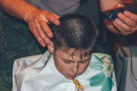 man doing a haircut boy teenager electric machineの写真素材