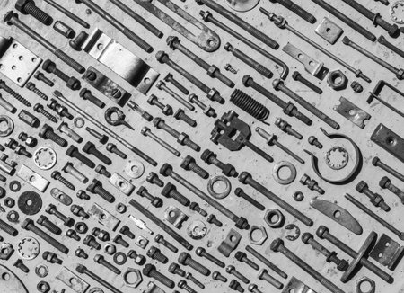 set of old rusty metal screws, nuts and bolts black and white photo. Flat lay, top view