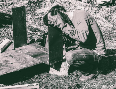 a welder puts the seam on the metal electro arc welding, black and white photo