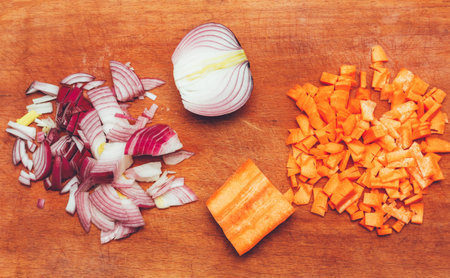 sliced onions and carrots on the cutting board top view