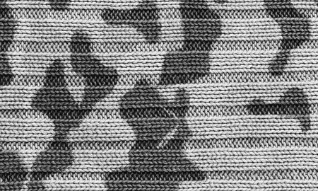 spotted camouflage texture knitted sweater close-up, black and white photo