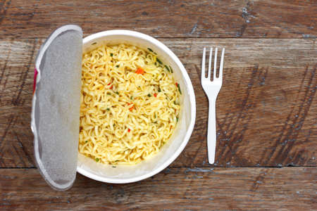 instant noodles on wooden background, top view close-upの写真素材