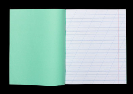 open school notebook in a narrow line with a slash for learning spelling, mock up with copy space isolated on black backgroundの写真素材