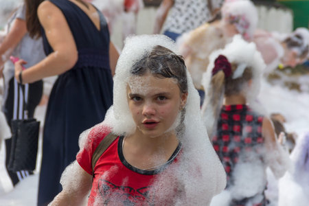 Kamennomostsky, Russia - September 1, 2018: Happy children having fun at a foam party at a holiday town day Kamennomostsky in an autumn parkのeditorial素材