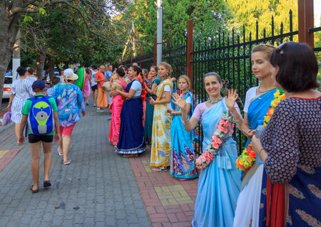 Sochi, Russia - August 21, 2018: beautiful and happy women and girls are hare Krishna in bright dresses dancing and singing on the streets of Sochi in the summerのeditorial素材