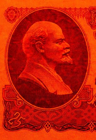 Abstraction of red color from a fragment of the Soviet banknote of 25 rubles in 1961 with a portrait of Vladimir Leninの写真素材